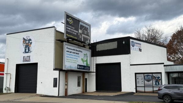 Elite Insulation building with advertising signs